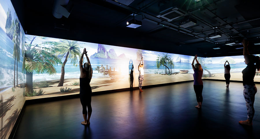 Immersive yoga studio with 360 screen displaying a beach scene at Studio Solutions